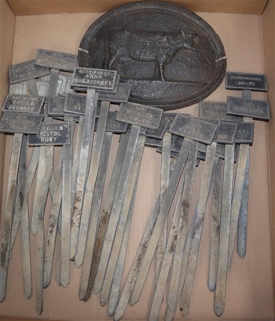 Thirty horticultural floral border markers and a cast iron churn table